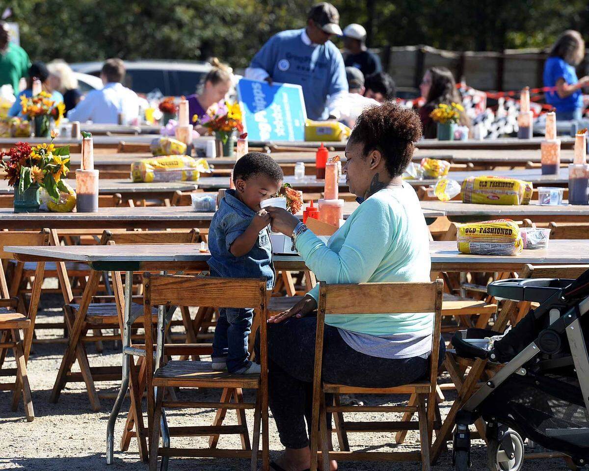 Kisha Lynch feeds her son Samir Brown, 15 months, as she enjoys barbecue at the Mallard Creek BBQ on Oct. 22, 2015.