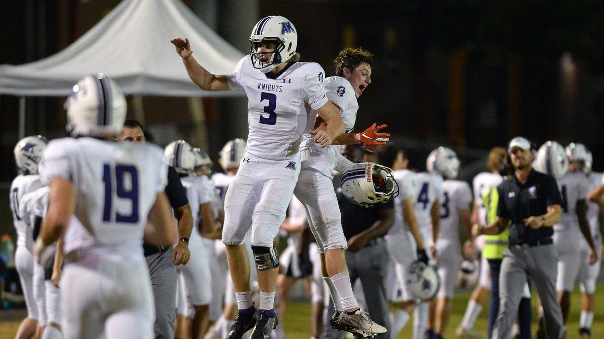 Ardrey Kell Knights quarterback Jack Curtis, center/left and safety Joshua Switzer, right/center, celebrate CurtisÕ touchdown pass to wide receiver Ethan Presutty during first half action against the South Meck Sabres on Friday, October 8, 2021. Ardrey Kell defeated South Meck 21-17.