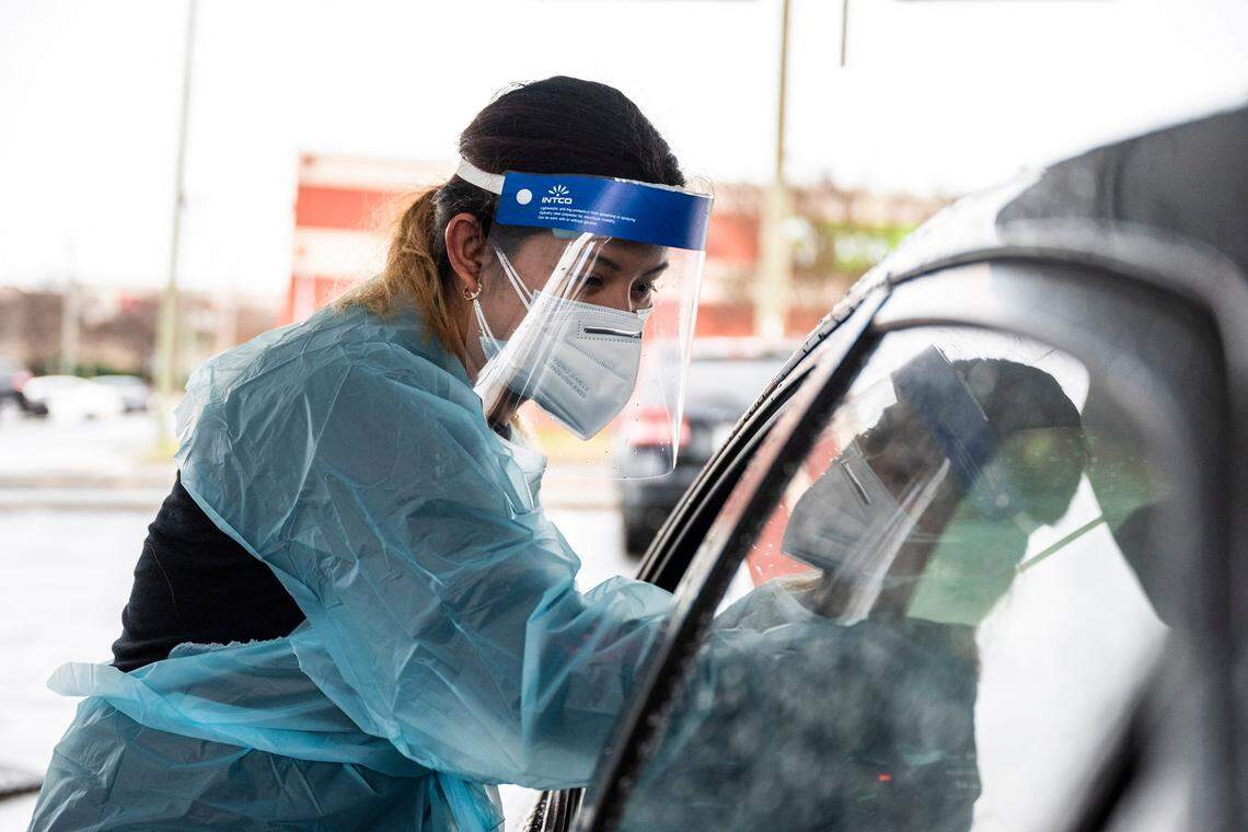 Certified Medical Assistant Marisol Cruz administers a COVID test at StarMed Healthcare on Tuckaseegee Road on Thursday, December 30, 2021 in Charlotte, NC.