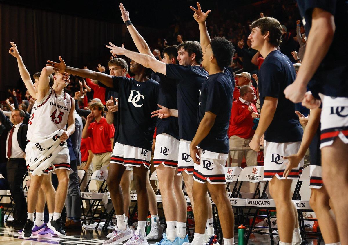 Davidson’s bench reacts after Zach Laput shoots a three-pointer to seal their lead over Charlotte in the final seconds of the Battle for the Hornets Nest at Belk Arena in Davidson, NC on Tuesday, December 10, 2024.
