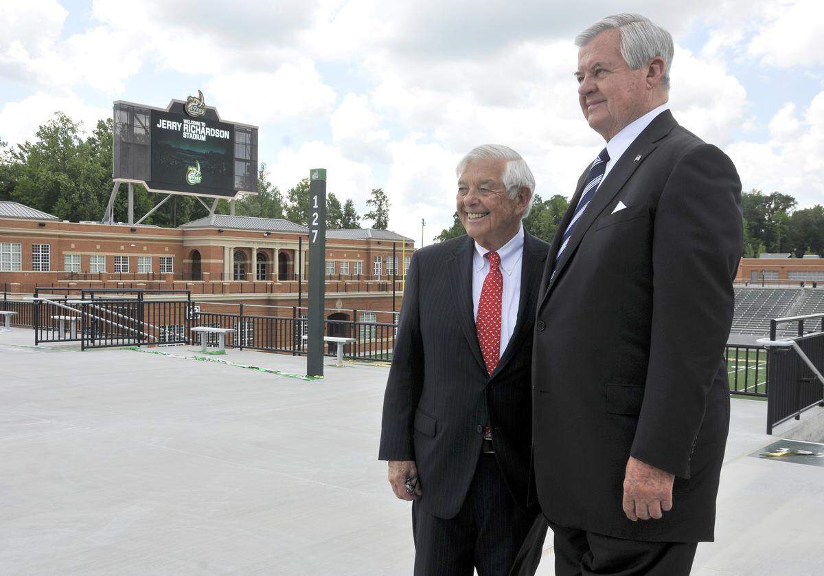 Businessmen Hugh McColl Jr. and Jerry Richardson stand in front of the Jerry Richardson Stadium and McColl-Richardson Field after a UNC Charlotte news conference to announce the naming of the 49ers’ new football stadium, which is called Jerry Richardson Stadium in honor of Richardson.