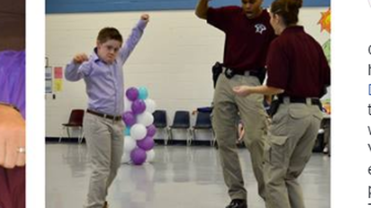 One of the students shows his dance moves with deputies as the Father/Daughter and Mother/Son Dance at Bonlee Elementary in Bear Creek.