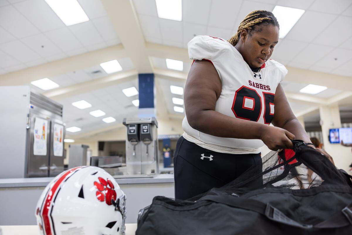 South Mecklenburg's female offensive lineman, Yazmine Beverly gets ready for a game after a weather delay at Hopewell High School in Huntersville, N.C., on Friday, September 26, 2025.