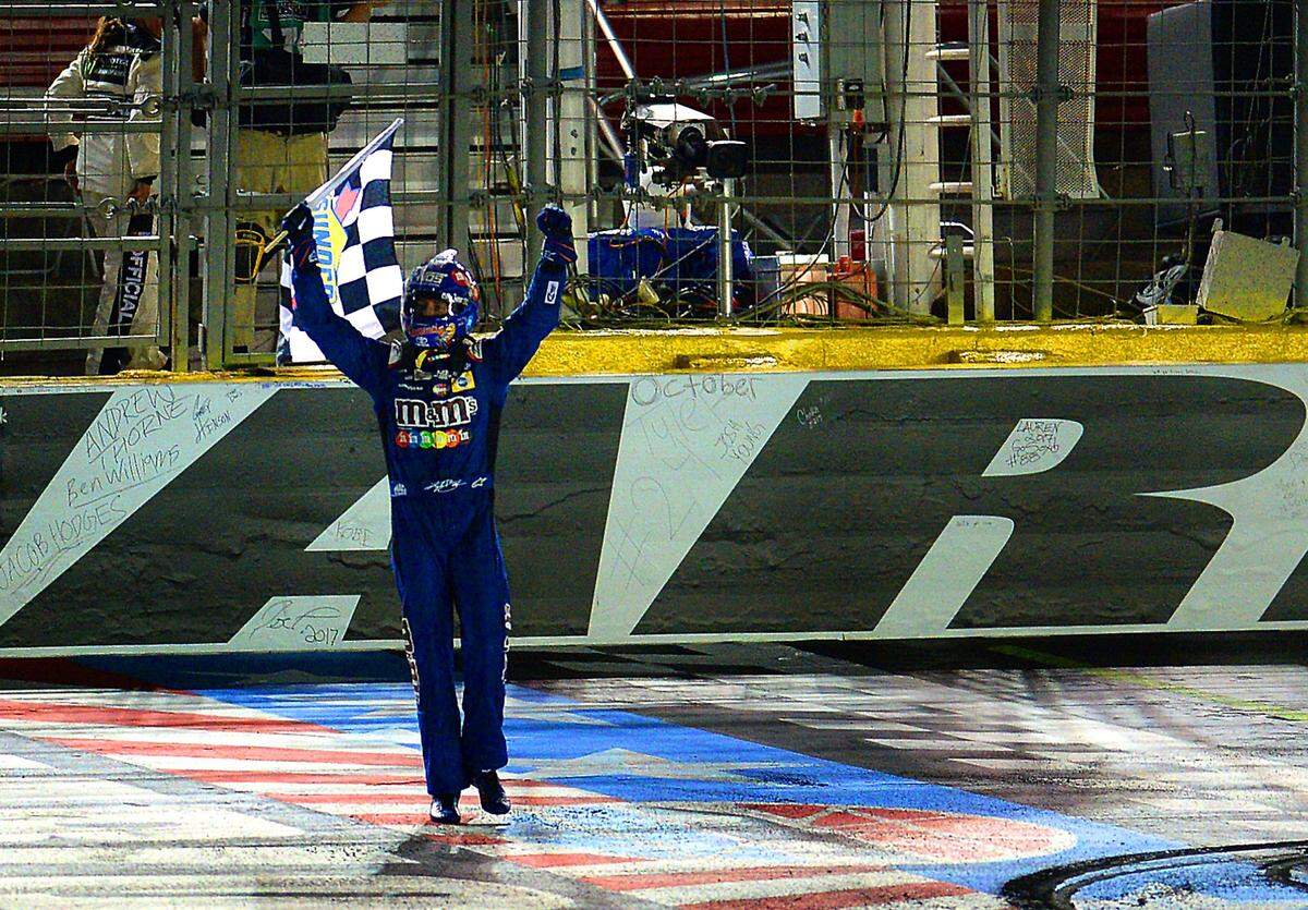 NASCAR driver Kyle Busch carries the checkered flag after winning the NASCAR Monster Energy All-Star Race on Saturday, May 20, 2017 at Charlotte Motor Speedway in Concord, NC. 