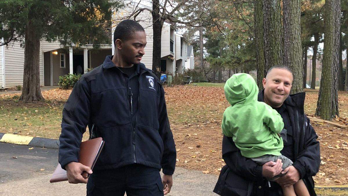 CMPD tweeted this photo at 9 am of officers carrying the lost boy back to his home