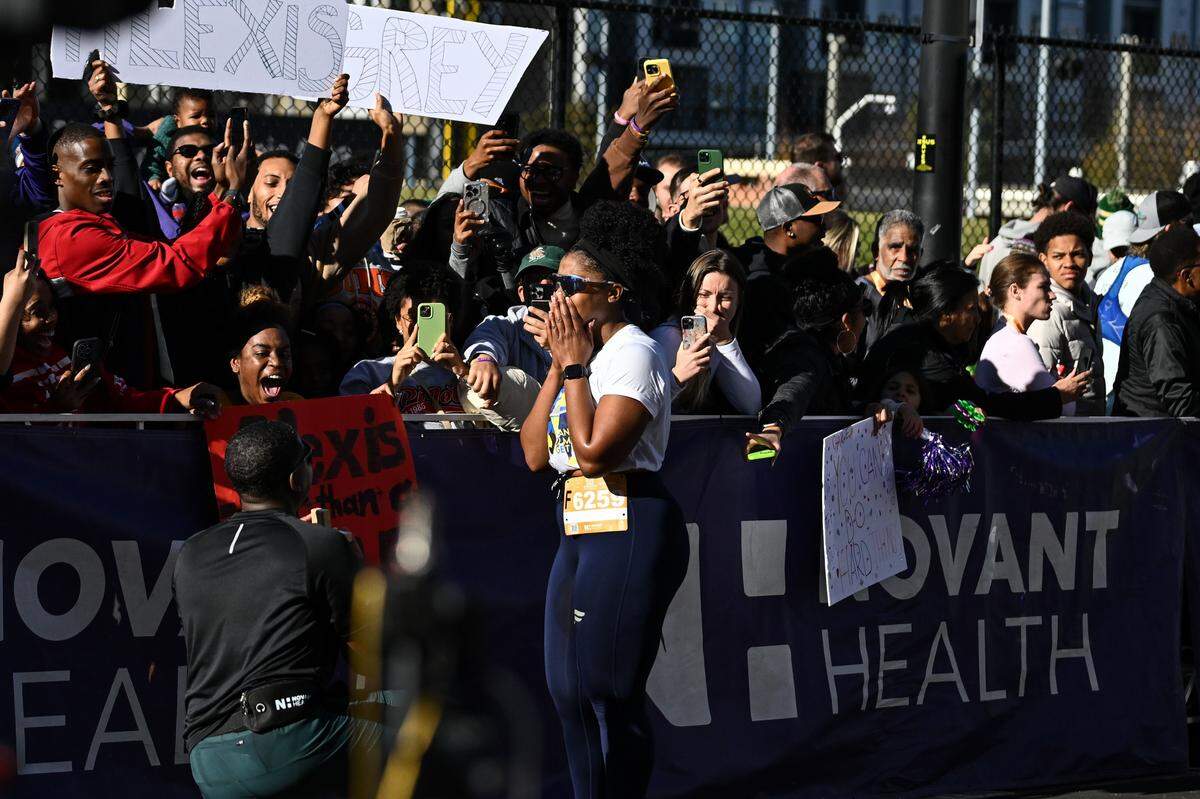 Grey Peoples, left, proposes to Alexis Montague after taking part in the 20th annual Novant Health Charlotte Marathon on Saturday, Nov. 16, 2024, in Charlotte