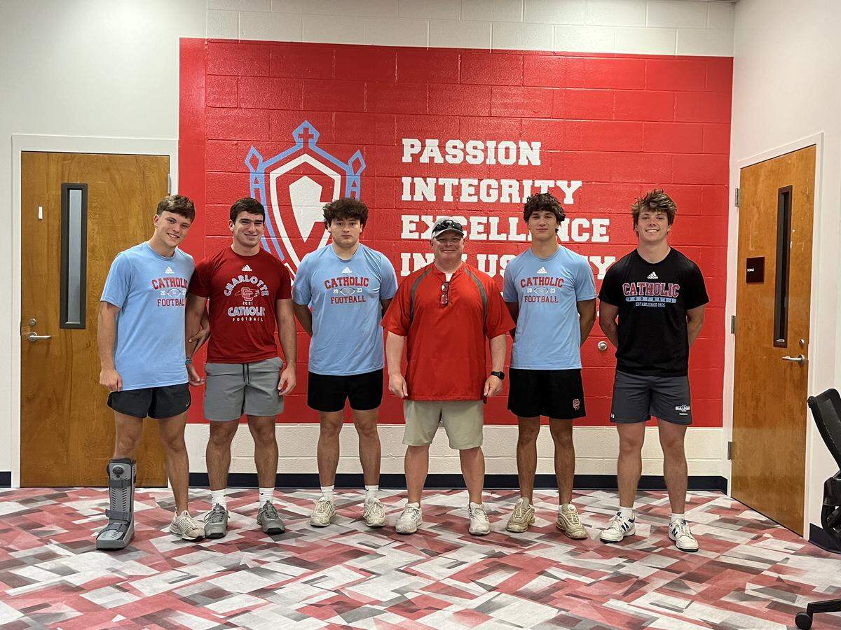 New Charlotte Catholic football coach Keith Emery with some of his new players