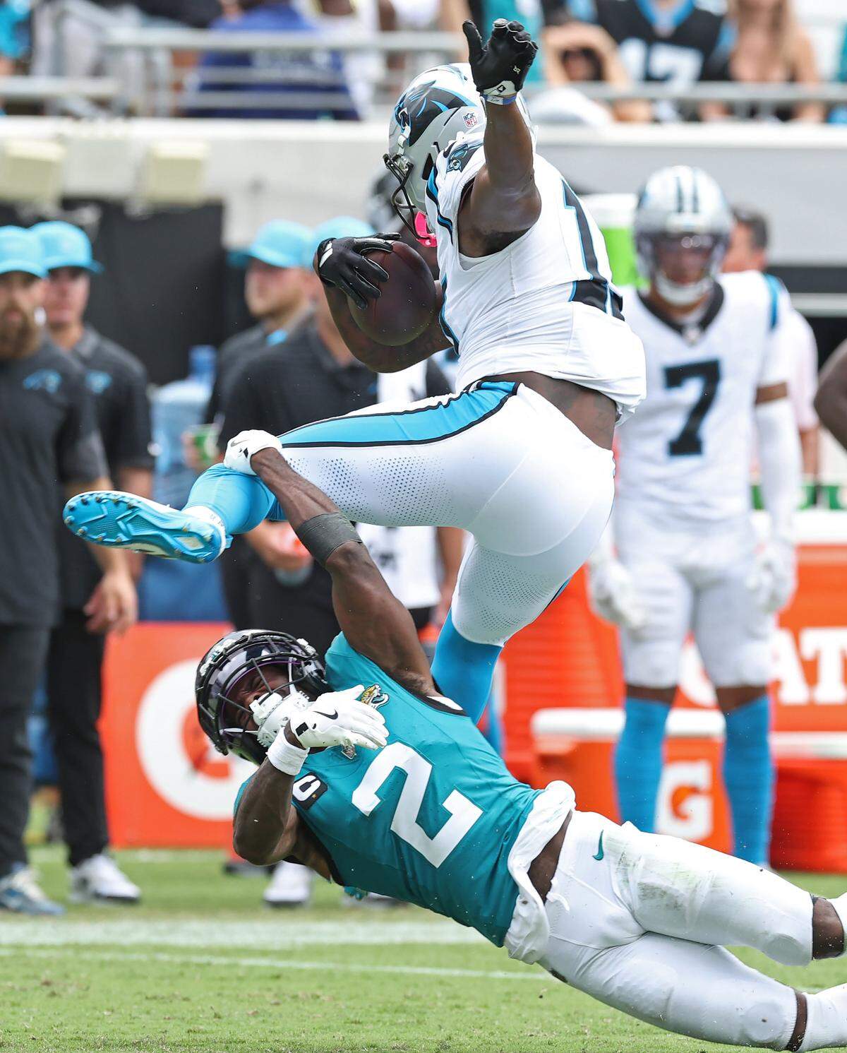 Carolina Panthers wide receiver Xavier Legette attempts to leap over Jacksonville Jaguars cornerback Jourdan Lewis following a pass reception during action on Sunday, September 7, 2025, at Everbank Stadium in Jacksonville, Florida.
