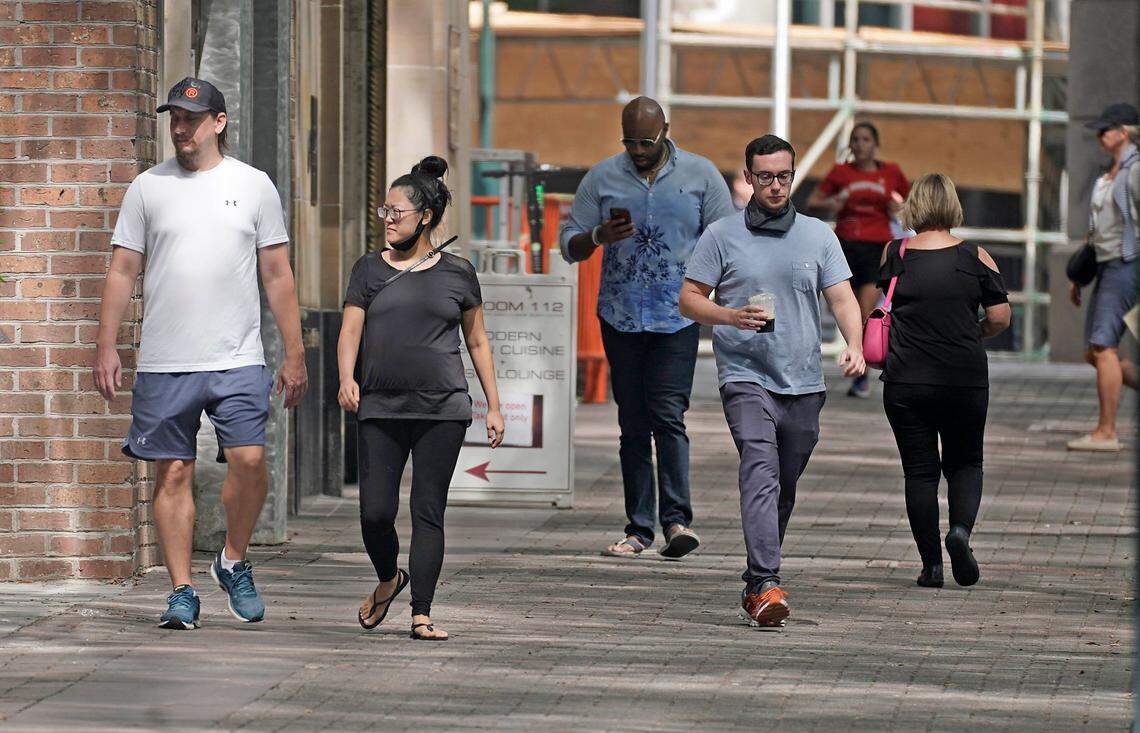 Pedestrians walk in uptown Charlotte on Wednesday, September 16, 2020.