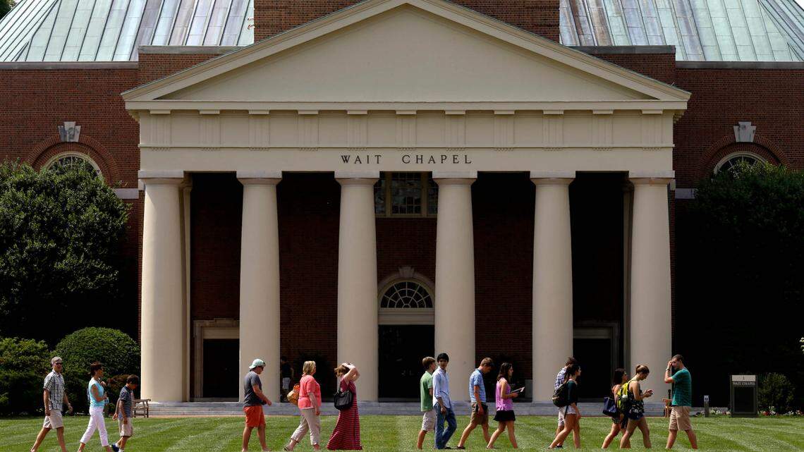 A group walks across the lawn on the campus of Wake Forest University in Winston-Salem, N.C. The school announced in an advisory that there are three reports of drugs found in alcoholic drinks.