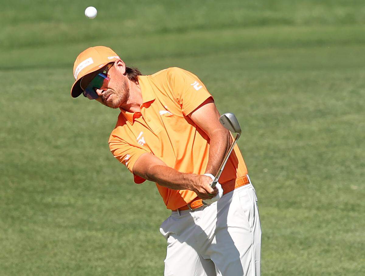 Rickie Fowler chips onto the 15th green during the final round of the Truist Championship at Quail Hollow Club in Charlotte, NC on Sunday, May 10, 2026. Fowler finished tied for second place at -13 for the championship.