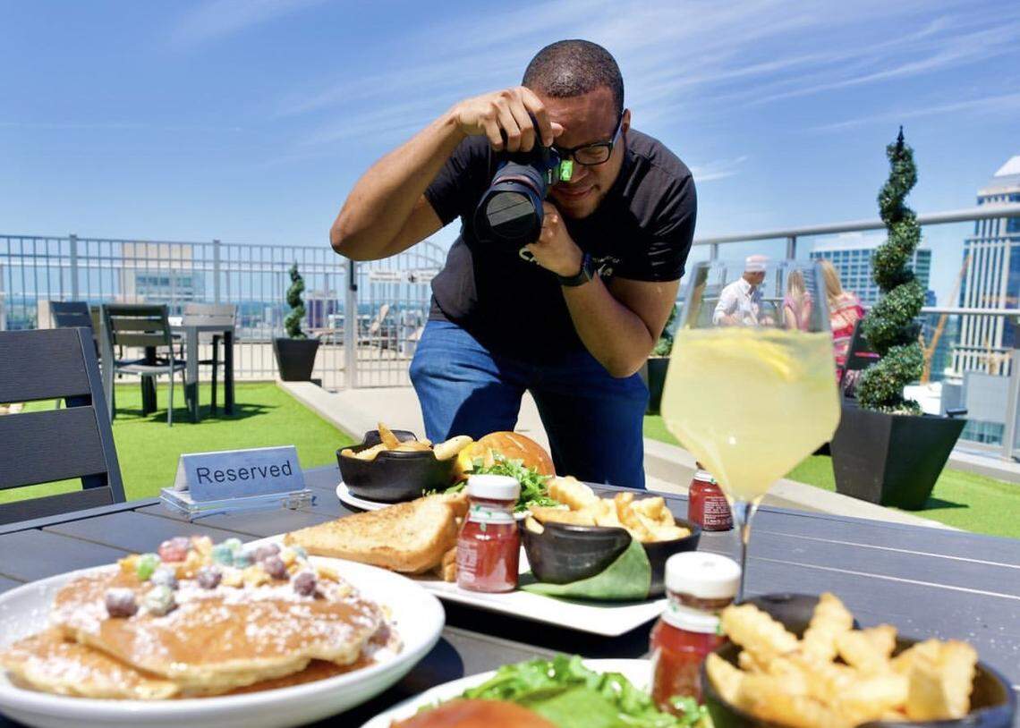 Cory Wilkins photographs dishes at Fahrenheit, a rooftop bar in uptown Charlotte.