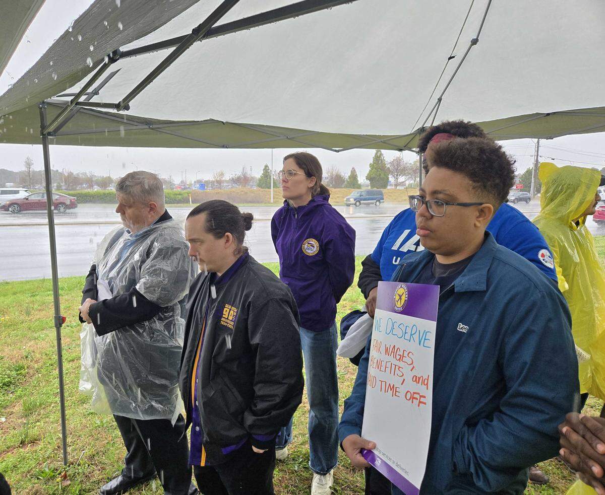 Members of the Service Employees International Union participate in a rally for more pay and benefits in a new lease agreement between the city of Charlotte and American Airlines.