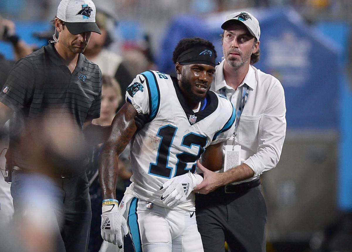 Carolina Panthers personnel tend to wide receiver Shi Smith, center, after he was injured during action against the Pittsburgh Steelers at Bank of America Stadium in Charlotte, NC on Friday, August 27, 2021.