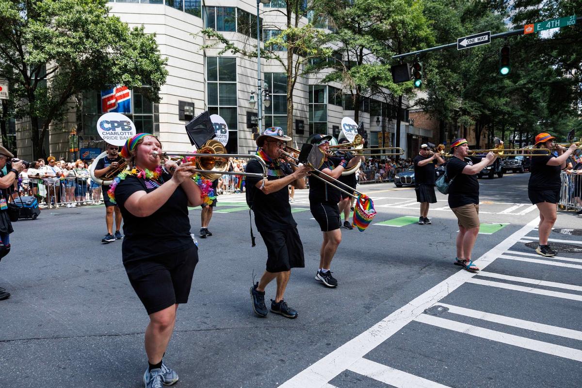 Members of the Charlotte Pride Band play their instruments as they turn the corner of Tryon and Fourth Street during the Charlotte Pride Festival & Parade on Sunday, Aug. 18, 2024