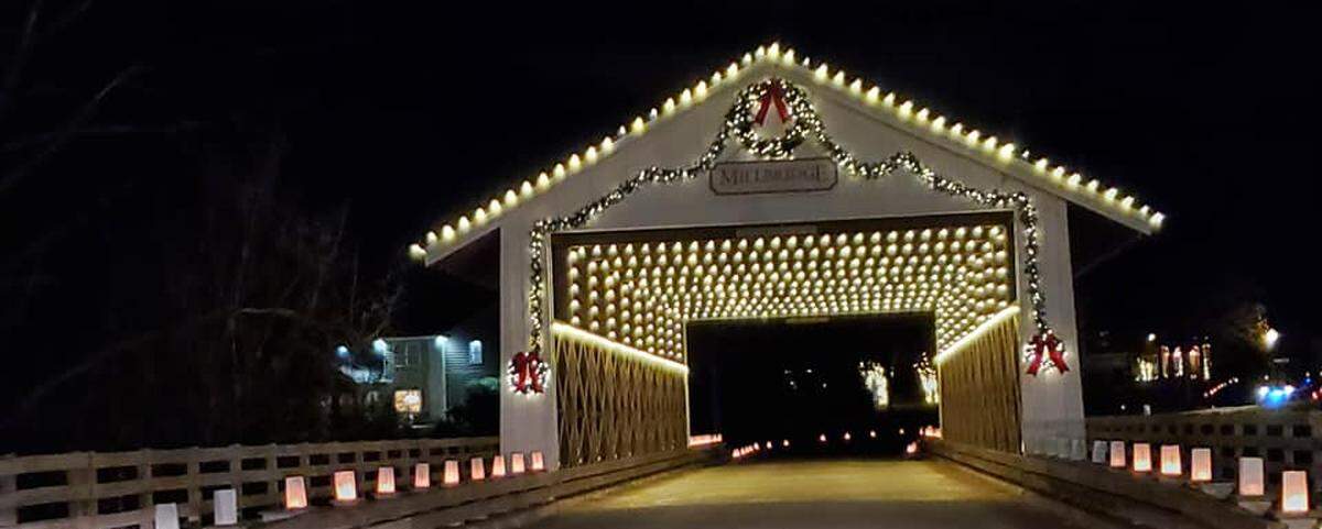 Your journey through Millbridge in Waxhaw includes a drive-thru bridge, lit up in holiday lights.