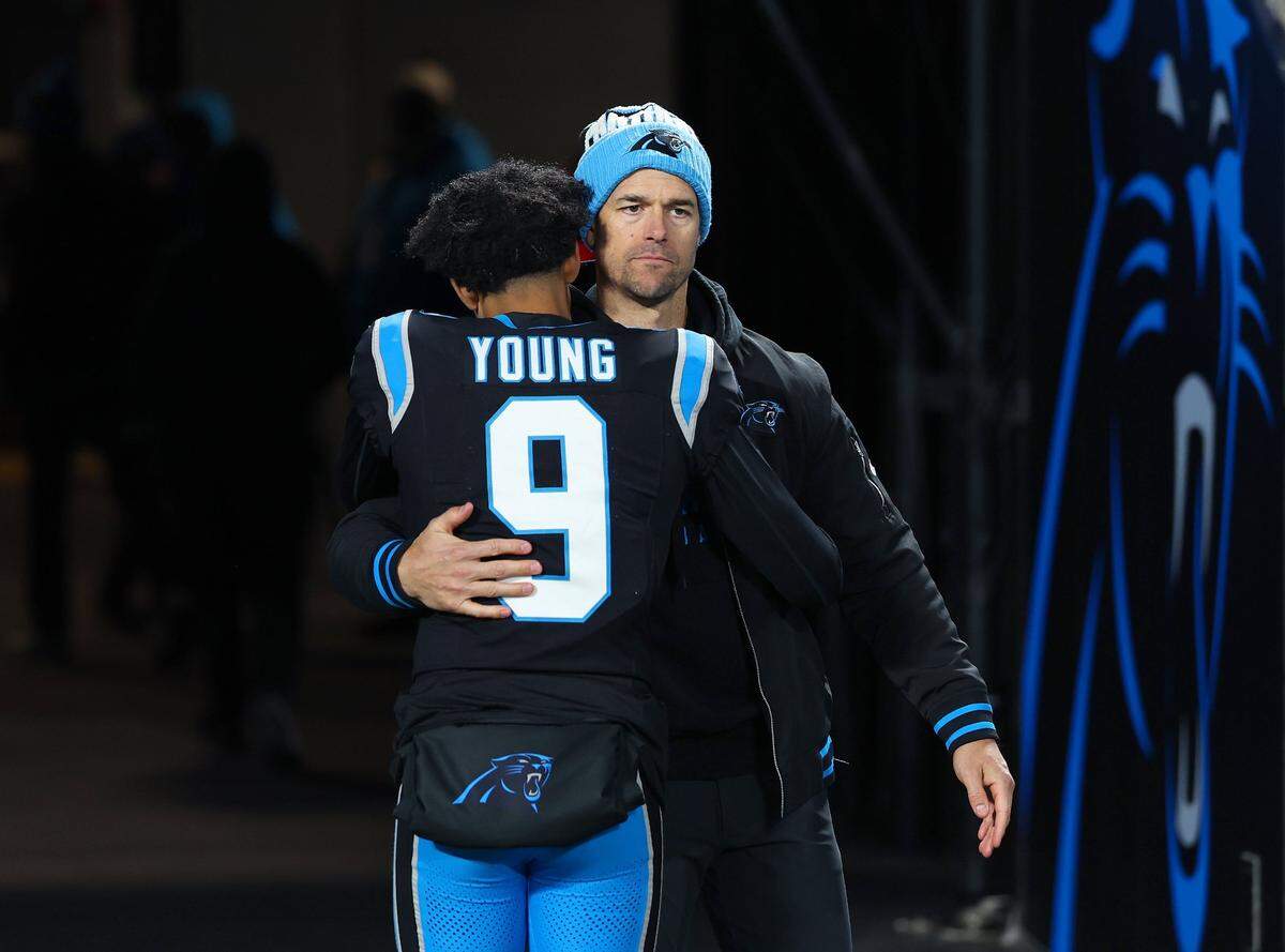 Carolina Panthers head coach Dave Canales (right) hugs quarterback Bryce Young following a loss in December. Canales said Monday that Young will return as the team’s starting quarterback in 2025.