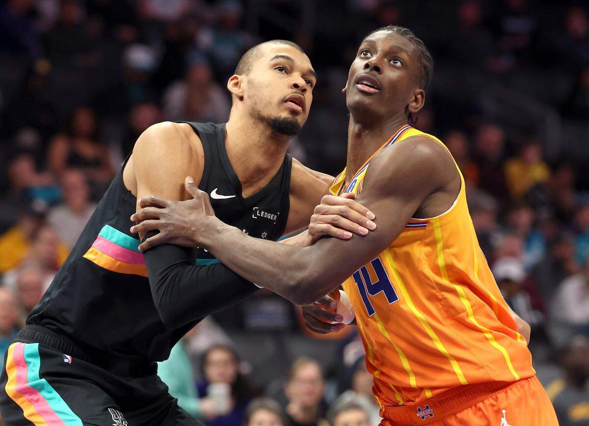 San Antonio Spurs center Victor Wembanyama, left, and Charlotte Hornets forward/center Moussa Diabaté battle in the lane during action at Spectrum Center in Charlotte, North Carolina, on Jan. 31, 2026.