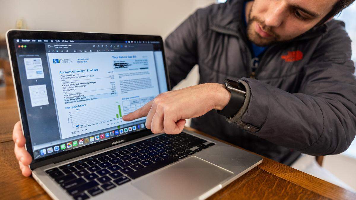Jack Miller shows his gas bills in Matthews, N.C., on Thursday, February 26, 2026.