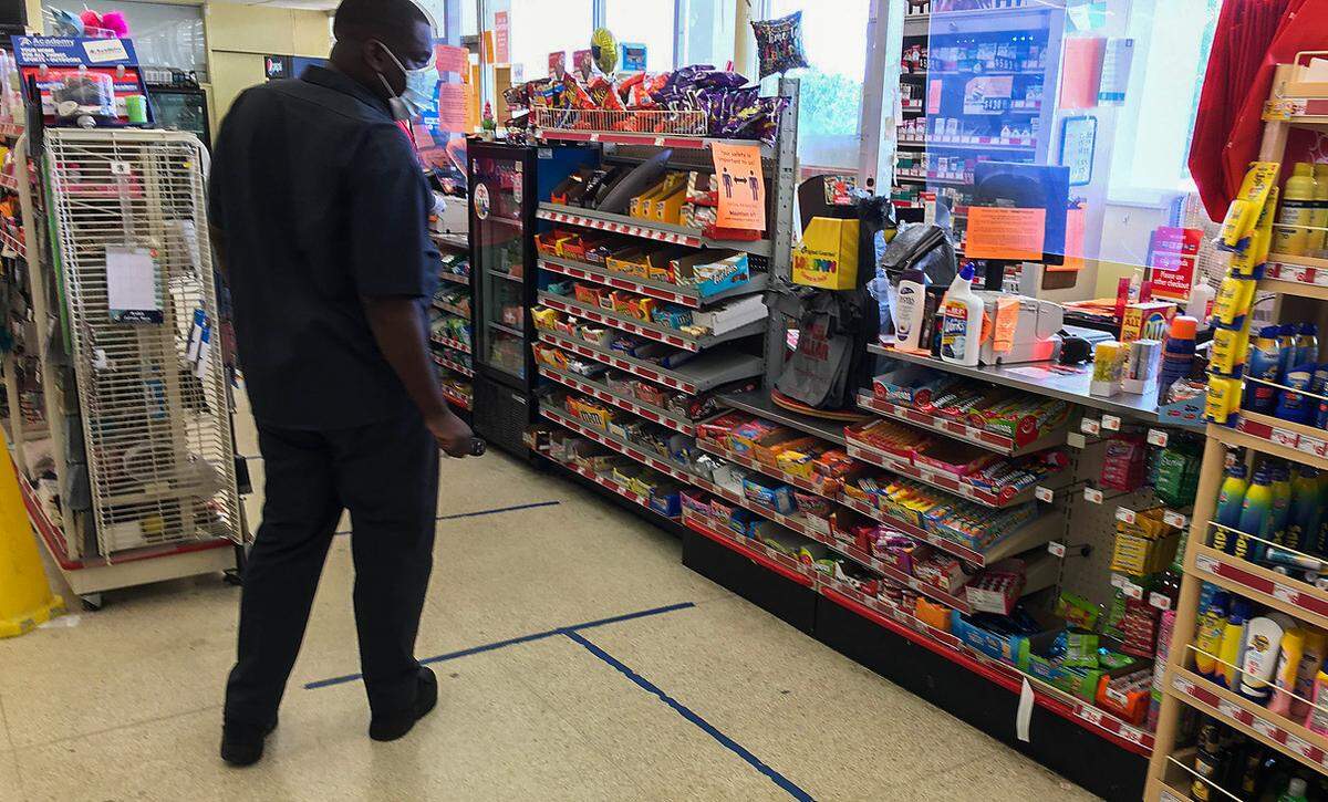 A customer at a Family Dollar store on South Boulevard walks up through the checkout line following the social distancing in May 2020 during COVID.