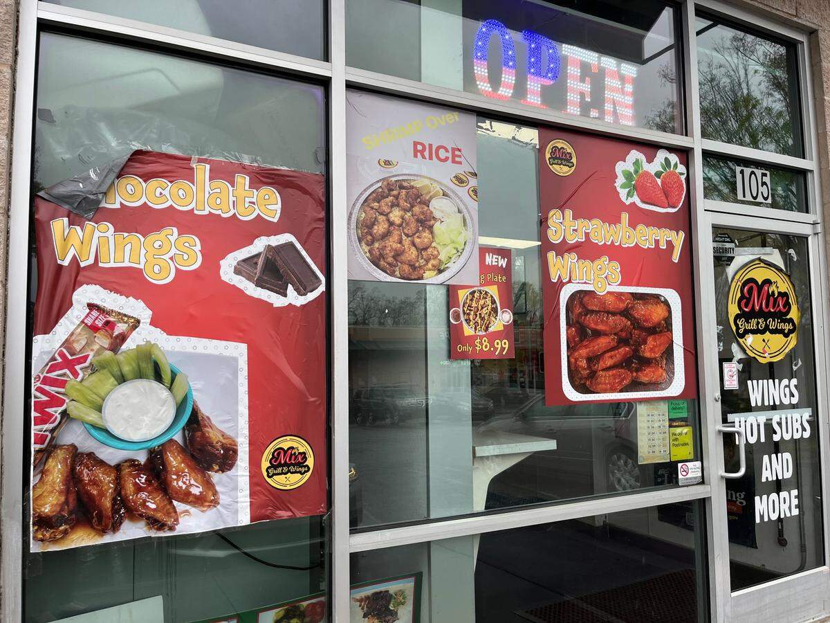 Signage outside Mix Grill & Wings showcases some of its biggest attention-getters, the chocolate and strawberry wings.