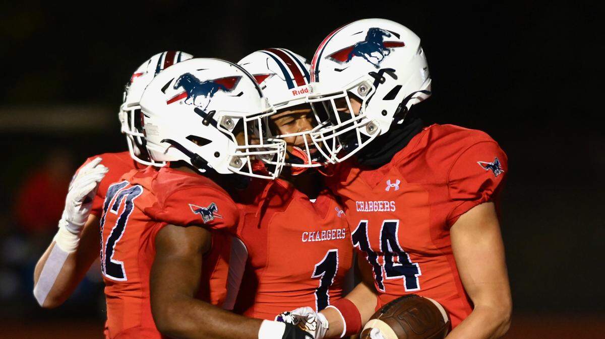 Providence Day’s Jayden Hollar, right, is congratulated by his teammates after catching a touchdown pass during first half action against Charlotte Christian on Friday, October 14, 2022. Jeff Siner/The Charlotte Observer