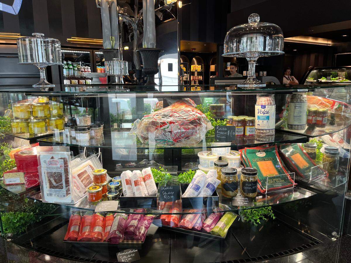 Glass cases show off a variety of charcuterie items at Gourmand Market.