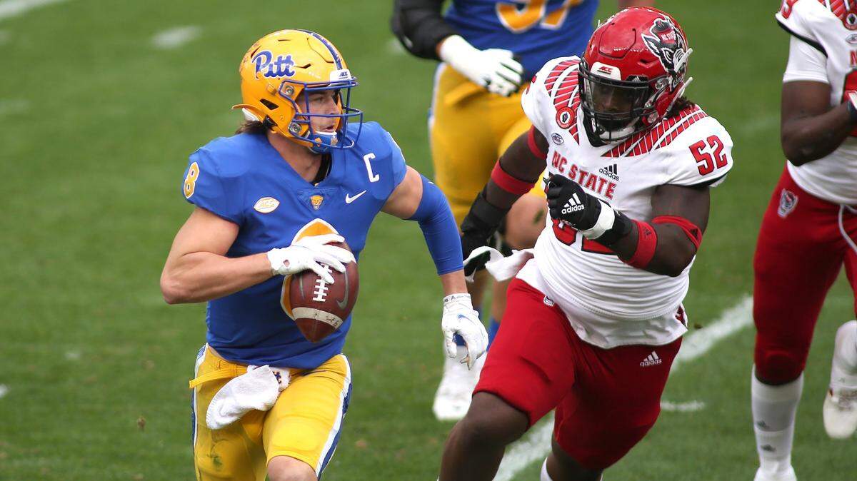 PITTSBURGH, PA - OCTOBER 03: Kenny Pickett #8 of the Pittsburgh Panthers attempts to avoid C.J. Clark #52 of the North Carolina State Wolfpack during the second half at Heinz Field in Pittsburgh, PA on October 3, 2020. (Photo by Michael Longo/Icon Sportswire)