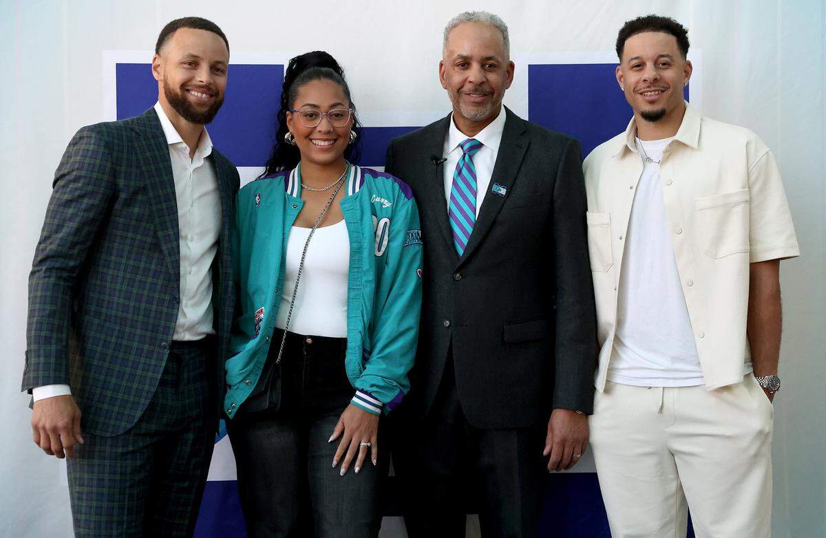 Steph Curry, Sydel Curry, Dell Curry and Seth Curry pose together during a reception Thursday for Dell Curry at Spectrum Center.