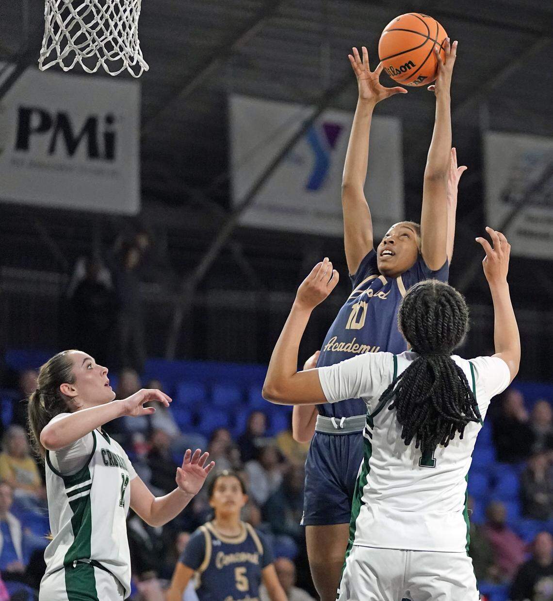 Concord Academy's Victorian Collins, center, goes for a rebound against Grace Christian's Kennedy Jackson, left, and Olivia Lewter during the first half of their N.C. Independent Schools Athletic Association 3A girls state championship game Friday, Feb. 27, 2026, in Greensboro, N.C. (Credit: Bill Kiser/Special to the Charlotte Observer)