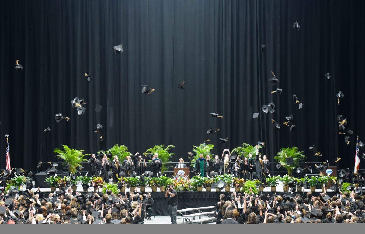 Providence High School graduates throw their mortarboards into the air moments after officially graduating High School on Wednesday, June 14, 2023, at Bojangles Coliseum.