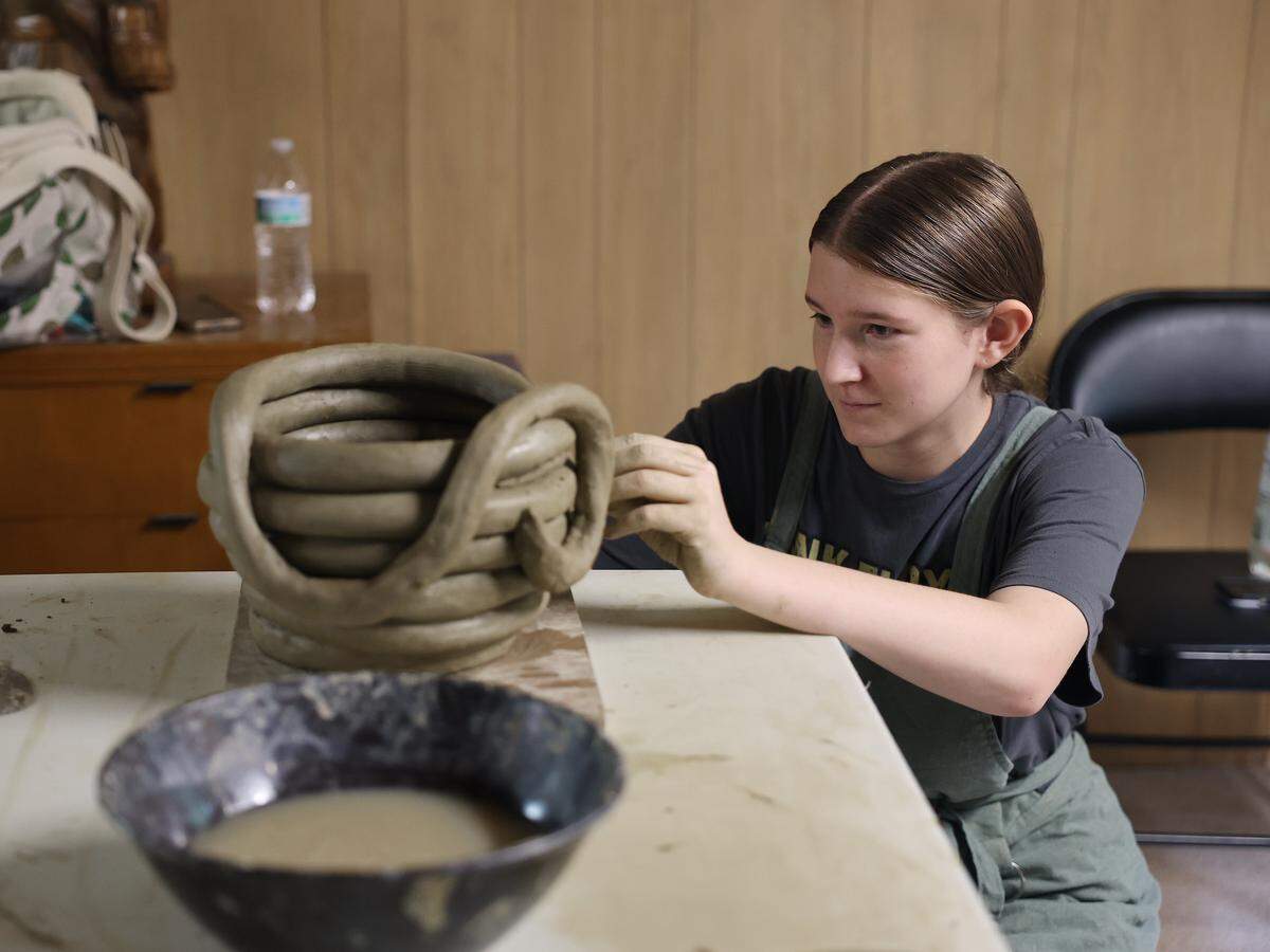 Maddison Totherow shapes a snake into a bowl Wednesday, July 30, 2025 at the Catawba Reservation in Rock Hill.