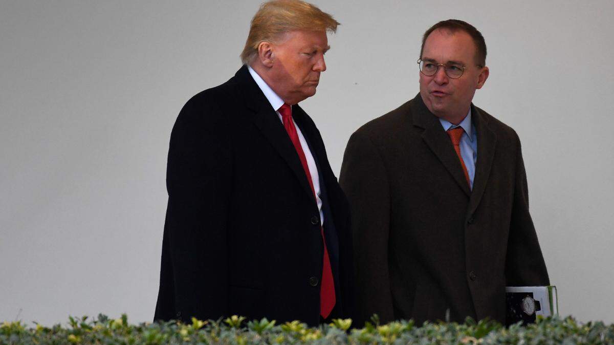 In this January 2020 photo, then-Acting White House Chief of Staff Mick Mulvaney and President Donald Trump walk along the colonnade at the White House in Washington, D.C.
