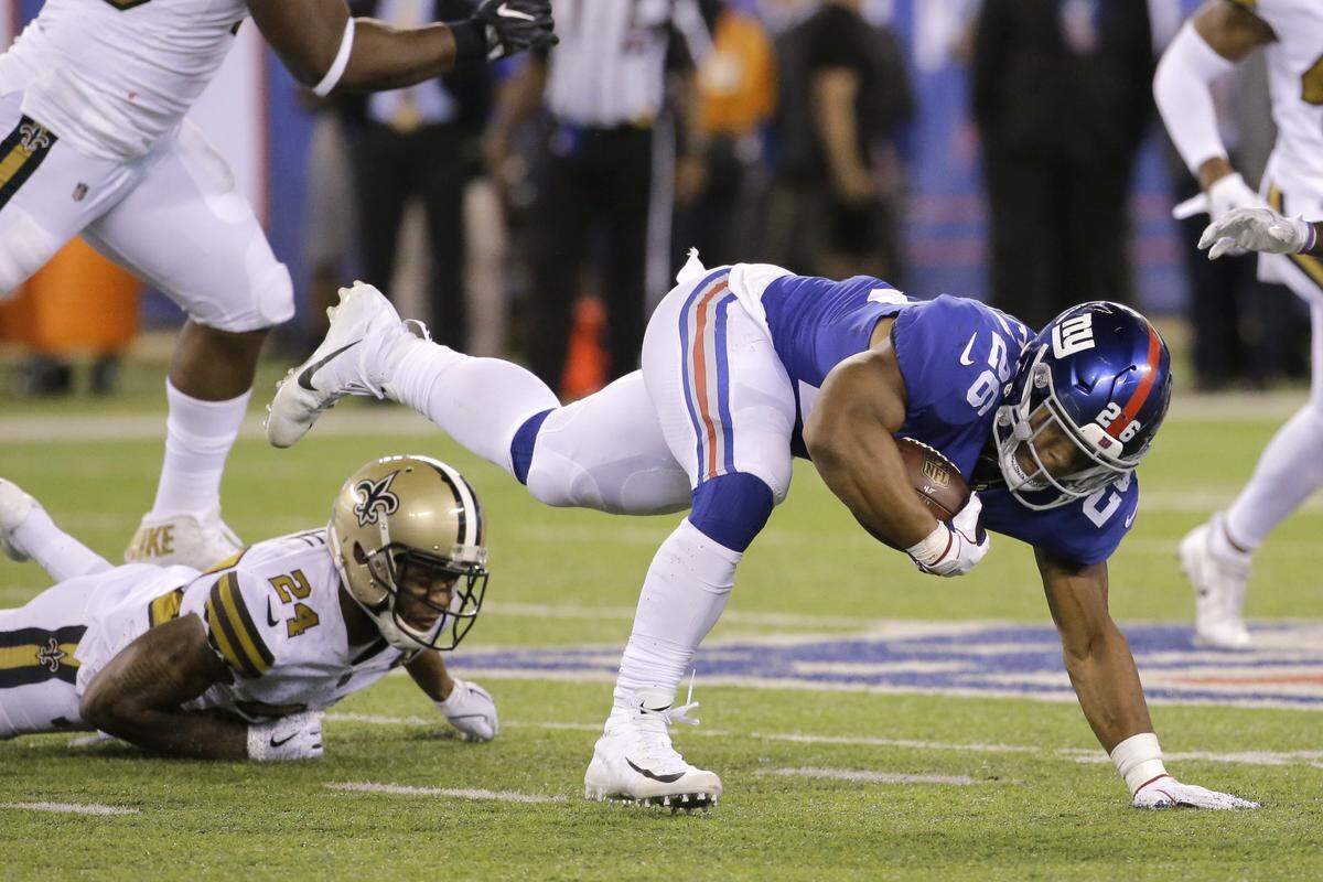 New York Giants rookie Saquon Barkley tries to regain his balance against the New Orleans Saints.