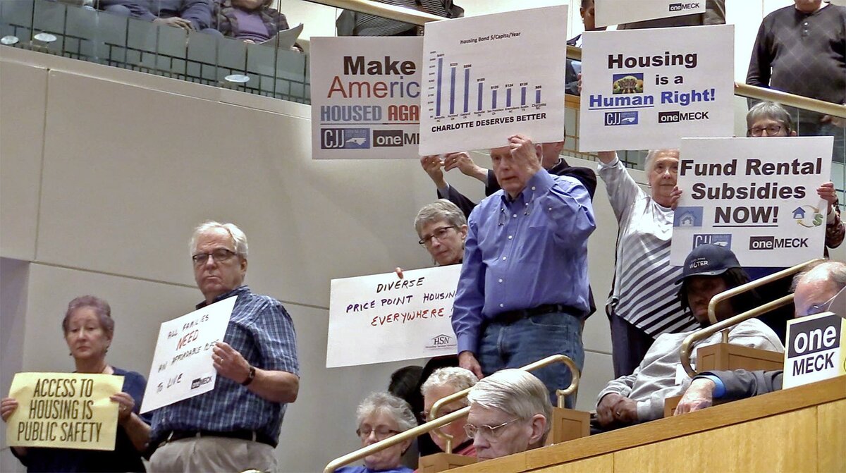 Citizens stand as speakers address the Charlotte City Council this month about the need for affordable housing.