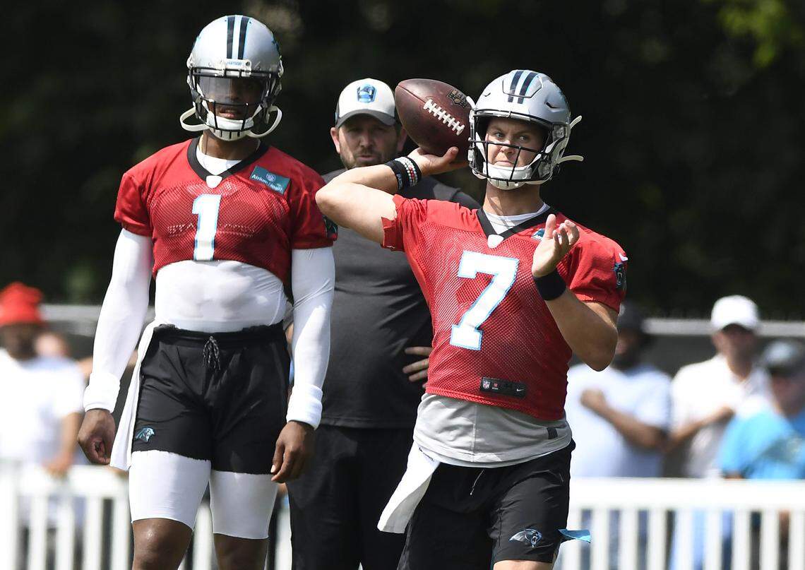 Carolina Panthers quarterback Kyle Allen (7) throws downfield during the team’s 2019 training camp while Cam Newton watches. Allen will start the preseason game at Chicago Thursday night; Newton will not play.