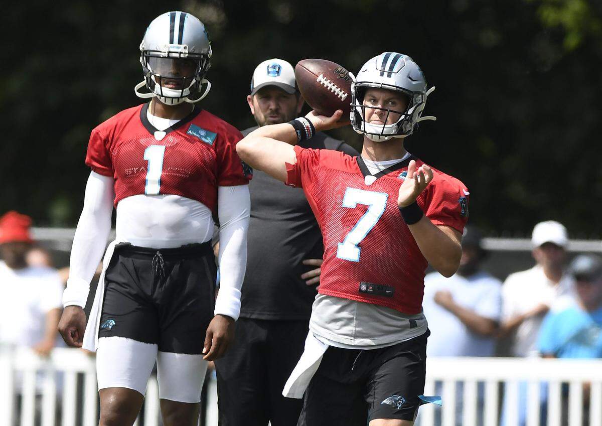 Carolina Panthers quarterback Kyle Allen (7) throws downfield during the team’s 2019 training camp while Cam Newton watches. Allen will start the preseason game at Chicago Thursday night; Newton will not play.