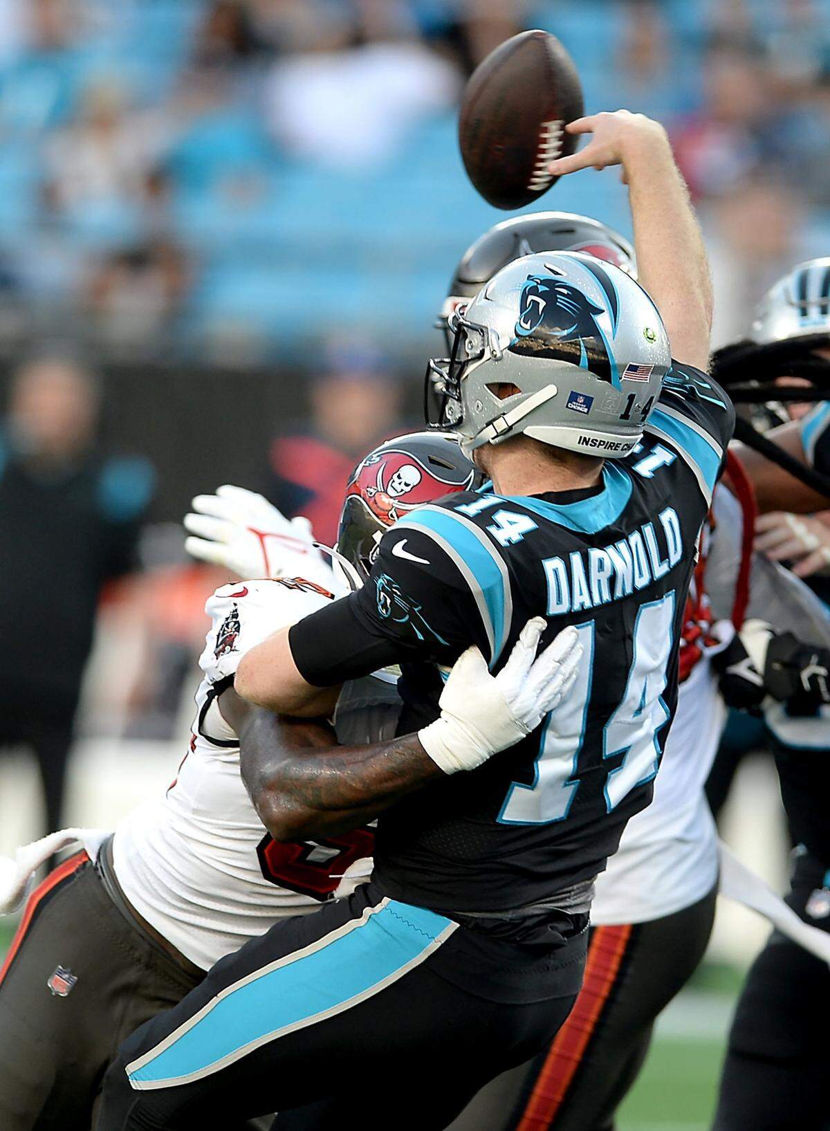 Carolina Panthers quarterback Sam Darnold, right, is hit by Tampa Bay Buccaneers linebacker K.J. Britt, left, during fourth quarter action on Sunday, December 26, 2021 at Bank of America Stadium in Charlotte, NC. The Buccaneers defeated the Panthers 32-6.