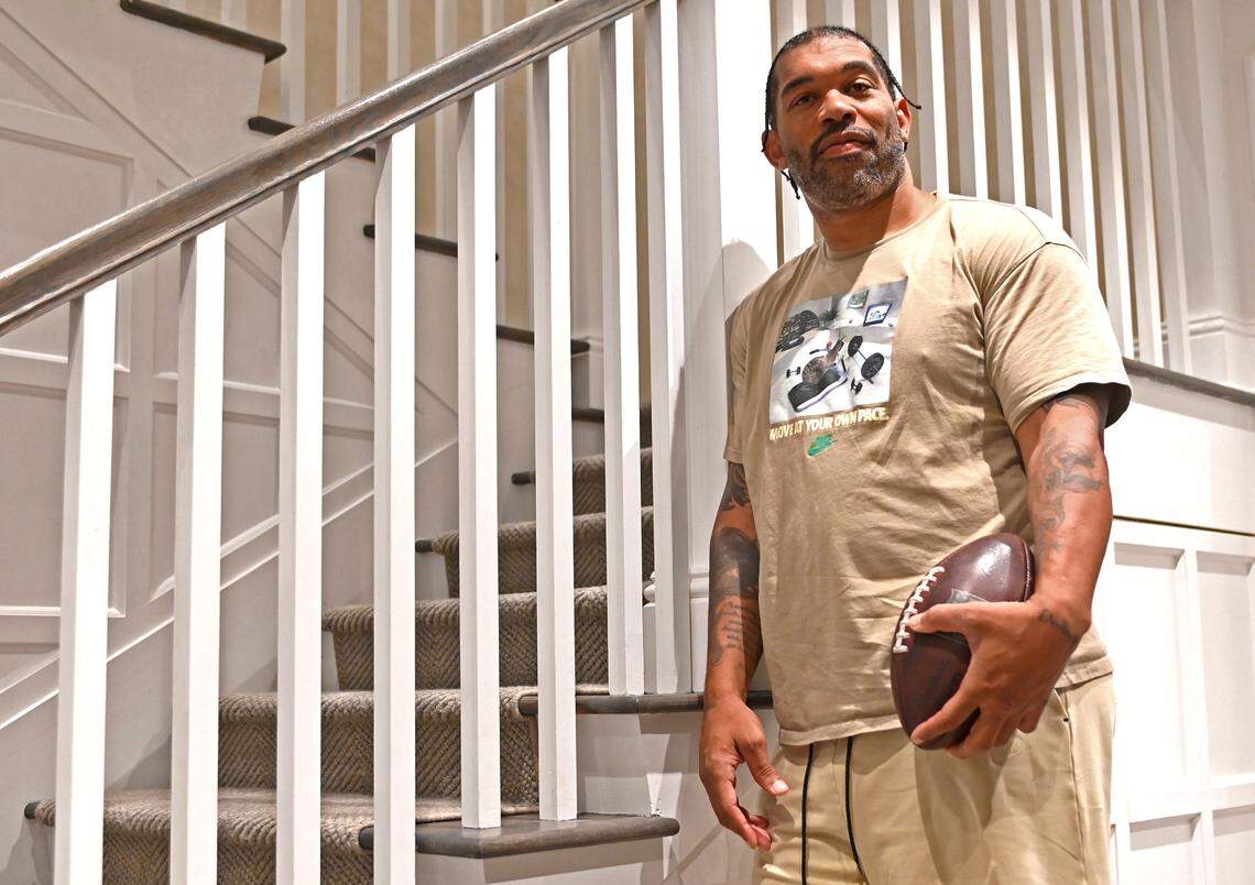 Former Carolina Panthers defensive end Julius Peppers in front of a staircase at his home in Coral Gables, Fla. Peppers spent 17 years in the NFL. The first eight years and the final two came with the Carolina Panthers, where he remains the team’s all-time sacks leader.