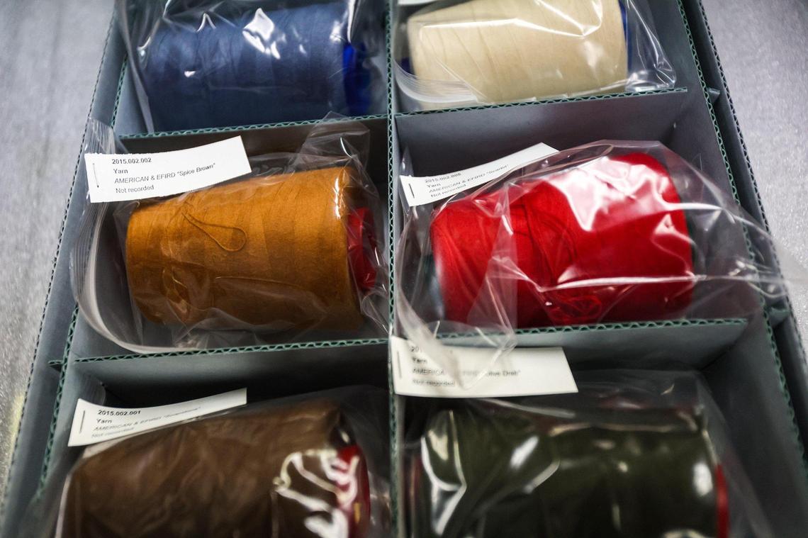 Spools of thread from an old textile plant sit in a box awaiting permanent display in the Levine Museum of the New South.