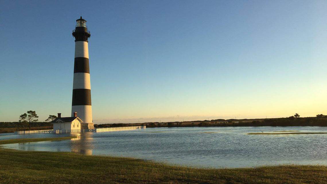 The historic Bodie Island Lighthouse and its light keeper’s home were surrounded by water early Friday after the passing of Tropical Storm Michael.