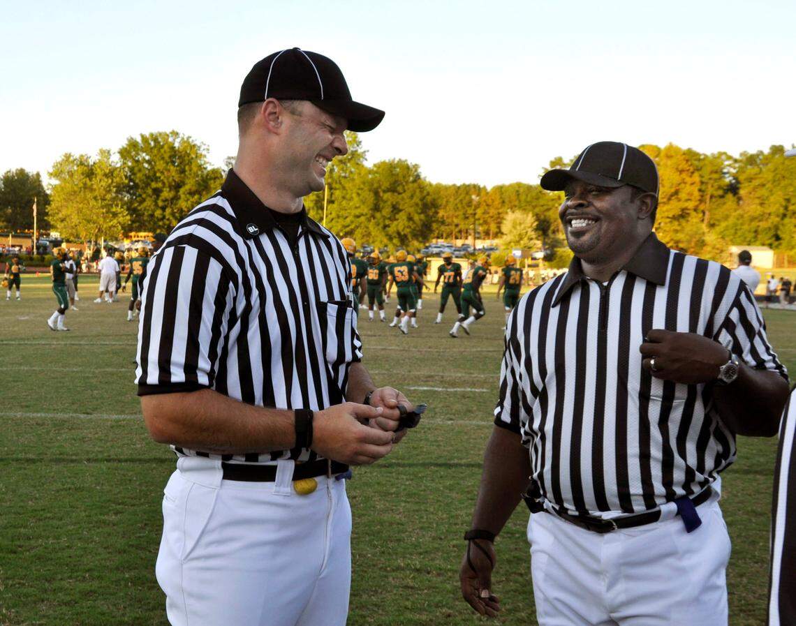 Mike Morton (Super Bowl winner and AL Brown High graduate) and Natrone Means (Super Bowl runner-up and Central Cabarrus High graduate) talk before acting as referees at a high school football game in Charlotte.