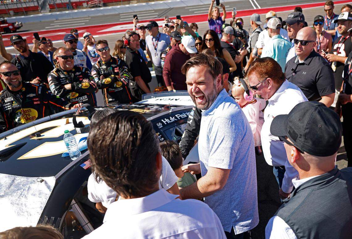 Vice Presidential Nominee Senator JD Vance, center, laughs with Donald Trump Jr., back to camera, along pit road at Charlotte Motor Speedway prior to the running of the Bank of America Roval 400 on Sunday, October 13, 2024 in Concord, NC.