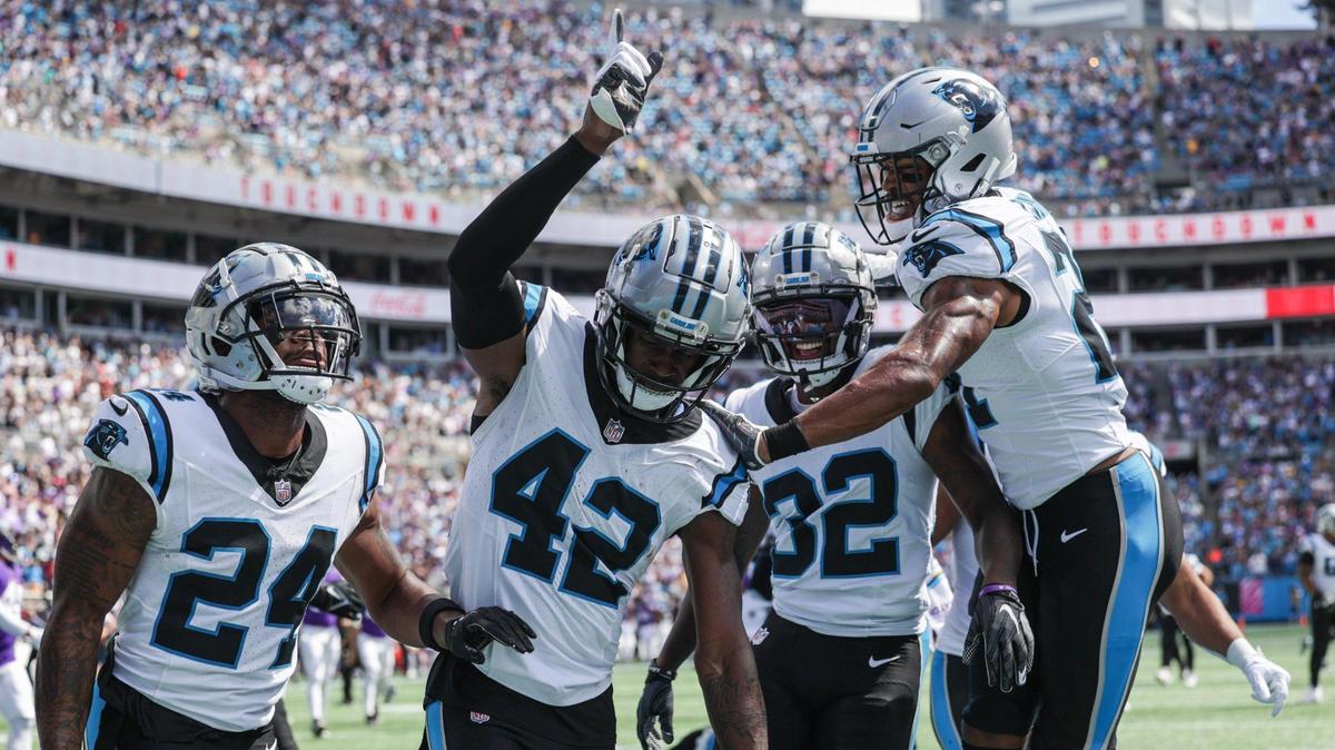Panthers safety Sam Franklin, Jr., second from left, celebrates in the end zone after a pick six during the game against Minnesota at Bank of America Stadium on Sunday, October 1, 2023 in Charlotte, NC.
