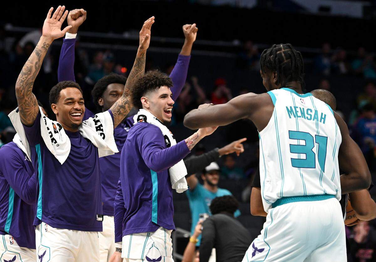 Charlotte Hornets center Nathan Mensah, right, is congratulated by teammates (L-R) forward P.J. Washington, center Mark Williams and guard LaMelo Ball following the team’s victory over the Oklahoma City Thunder on Sunday, October 15, 2023 at Spectrum Center in Charlotte, NC. The Hornets defeated the Thunder 117-115.