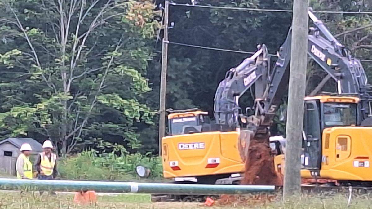 Crews dig red clay soil along Brawley School Road in Mooresville between Interstate 77 exit 35 and St. Therese Catholic Church on Saturday, Sept. 14, 2024, as part of the road’s widening from the interstate to U.S. 21.
