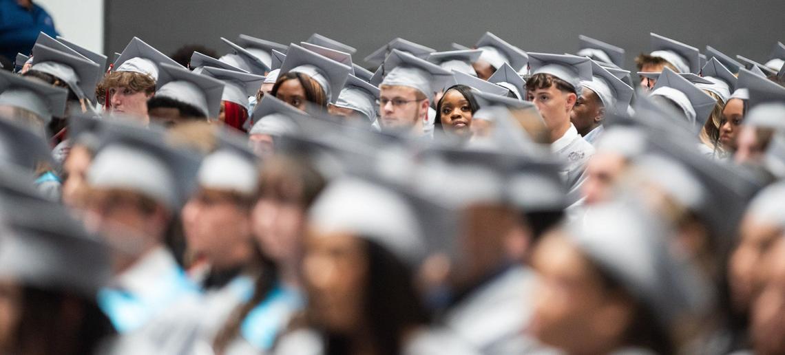 David W. Butler High School graduates listen to various speeches before going onto the stage to receive their diplomas at the Bojangles Coliseum in Charlotte on Monday, June 10, 2024.