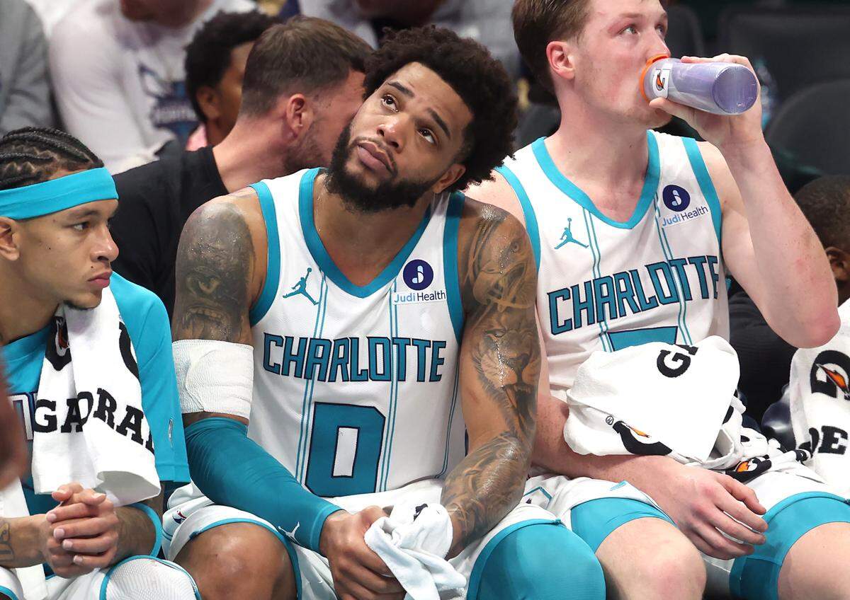 Charlotte Hornets forward Miles Bridges, center, sits on the team’s bench dejected in the final moments of action against the Orlando Magic at Spectrum Center in Charlotte, NC on Thursday, October 30, 2025. The Magic defeated the Hornets 123-107.