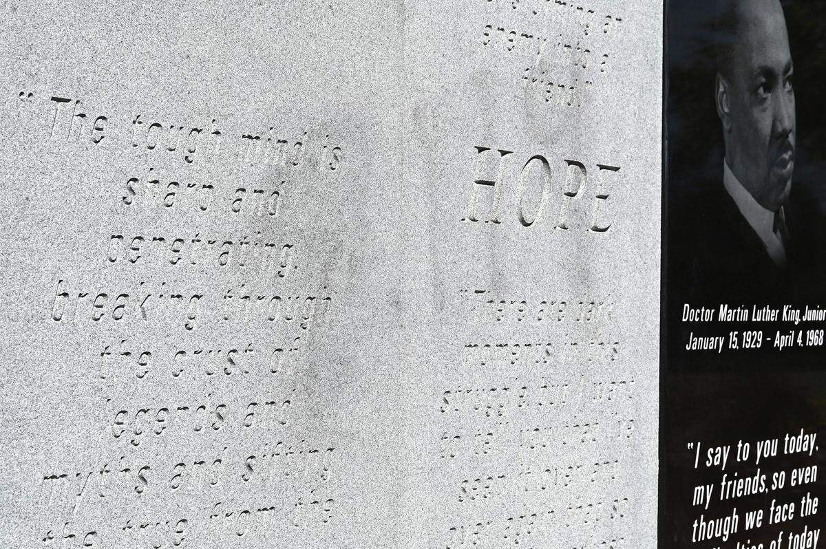Graffiti is faintly visible on the Dr. Martin Luther King Jr., monument on Cabarrus Avenue in Concord, NC on Monday, October 9, 2023. Over the weekend the monument was vandalized.