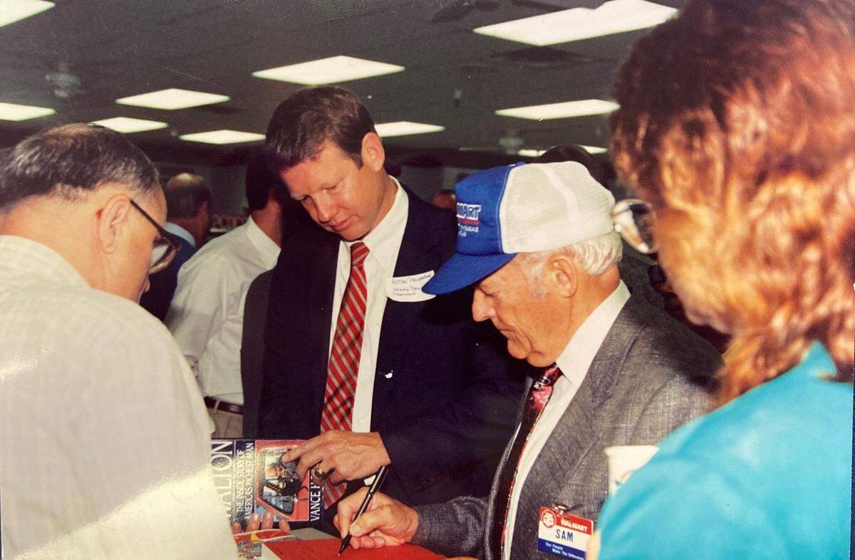 George “Steele” Dewey III, left, joins Walmart founder Sam Walton at the opening of a Walmart store at Eastway Crossing in Charlotte during the 1990s. Dewey developed the center.
